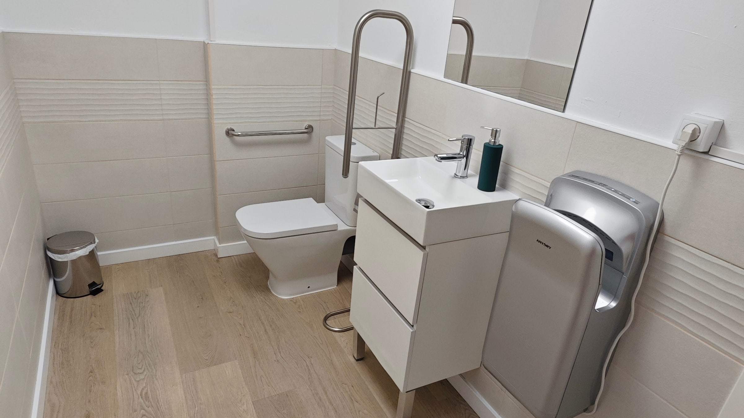 Lavabo adaptado con barras de apoyo, lavamanos y secamanos eléctrico